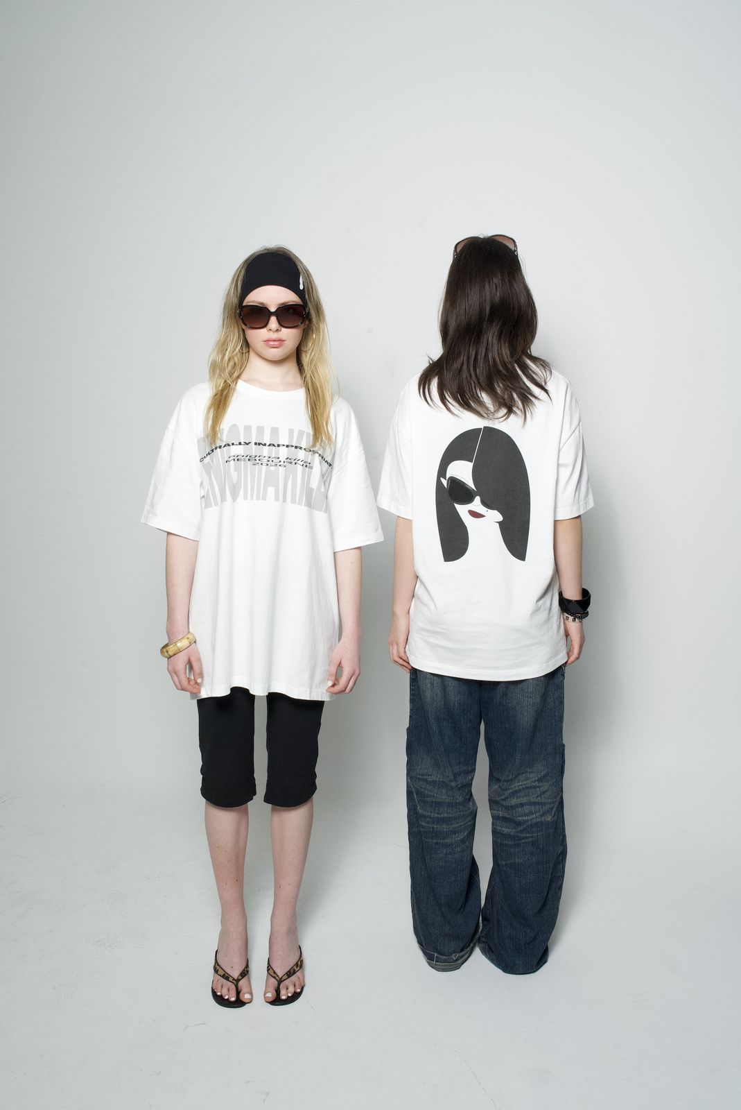 Two models in oversized printed tees, one facing forward and one facing away